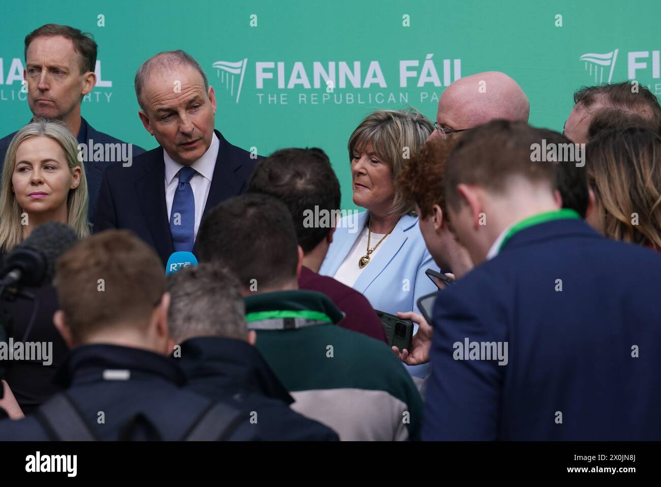 Tanaiste Micheal Martin (3rd left) speaks to the media ahead of the Fianna Fail Ard Fheis, at the Dublin Royal Convention Centre. Picture date: Friday April 12, 2024. Stock Photo