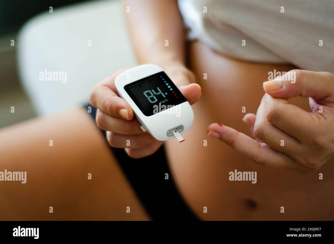 Pregnant woman using a to mesure blood sugar. Healthy habits