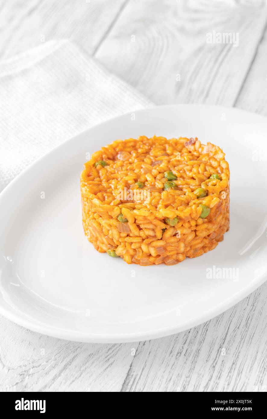 Portion of risotto with chorizo sausage and green peas Stock Photo