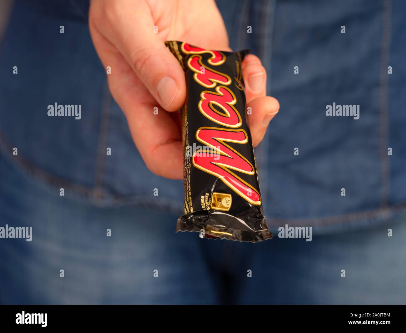 Tambov, Russian Federation - January 23, 2024 A woman holding out a Mars chocolate bar Stock Photo