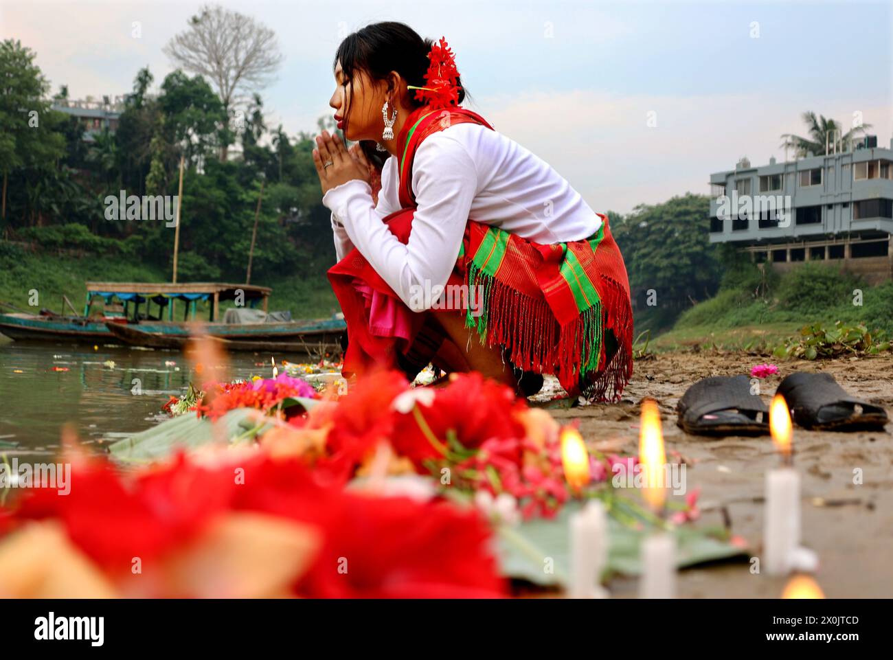 April 12, 2024, Rangamati, Rangamati, Bangladesh: In Bangladesh's Rangamati Lake, children, teenagers and young people wear their traditional clothes and take part in floating flowers in the water. Baisabi music is playing throughout the mountains to welcome the new year. As always, the small ethnic groups of the hills are making various arrangements to welcome the new year. As part of this, the people of Chakma and Tanchangya communities are celebrating their traditional 'Ful Biju' festival by floating flowers to wish the well-being of all nations. (Credit Image: © Mohammed Shajahan/ZUMA Pres Stock Photo