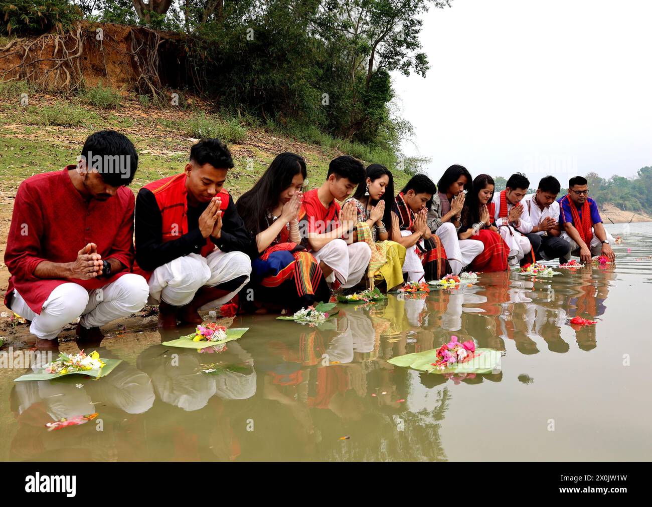 April 12, 2024, Rangamati, Rangamati, Bangladesh: In Bangladesh's Rangamati Lake, children, teenagers and young people wear their traditional clothes and take part in floating flowers in the water. Baisabi music is playing throughout the mountains to welcome the new year. As always, the small ethnic groups of the hills are making various arrangements to welcome the new year. As part of this, the people of Chakma and Tanchangya communities are celebrating their traditional 'Ful Biju' festival by floating flowers to wish the well-being of all nations. (Credit Image: © Mohammed Shajahan/ZUMA Pres Stock Photo