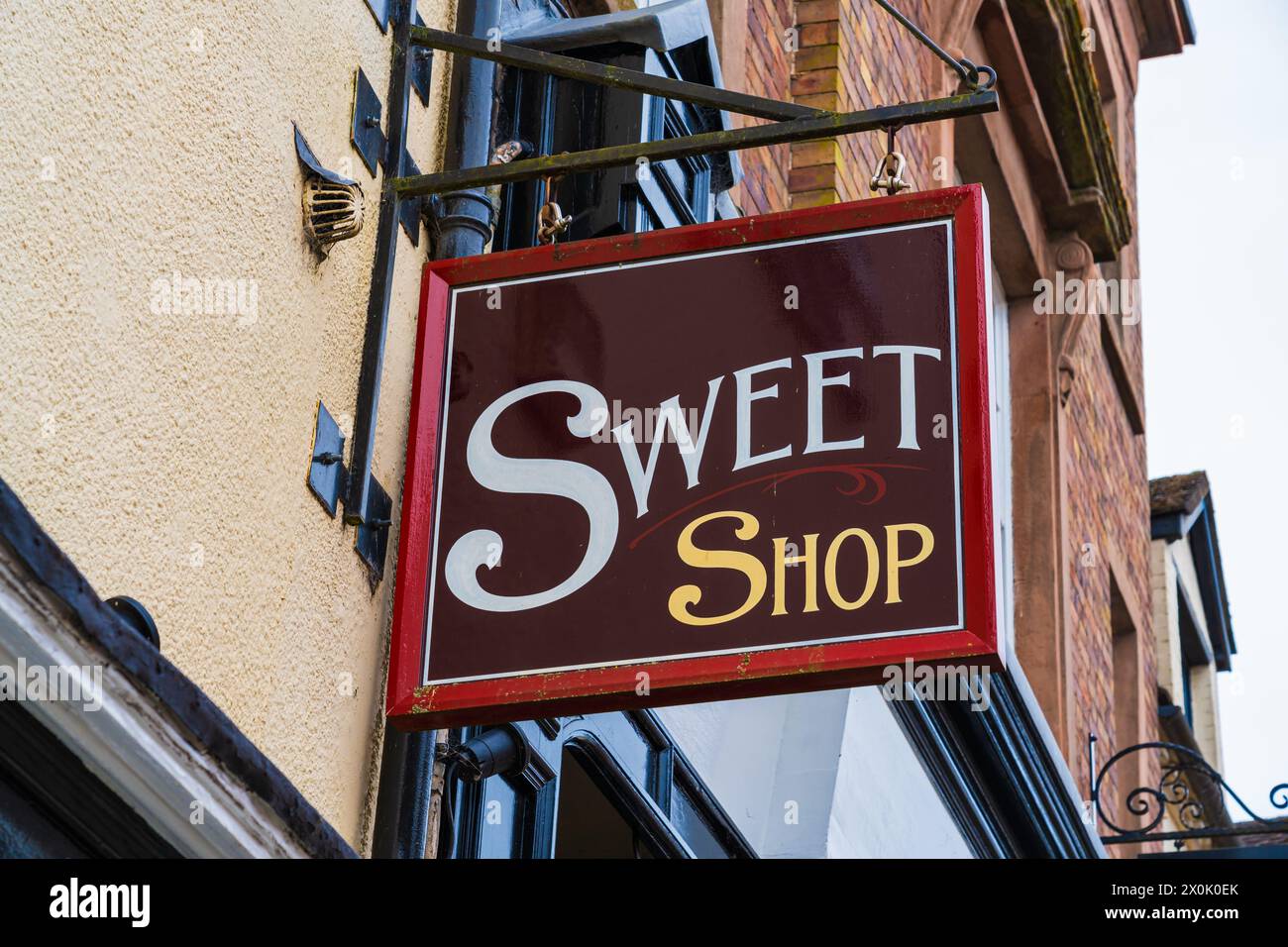 Sign board for a sweet shop, Hanging sign outside a candy store Stock Photo