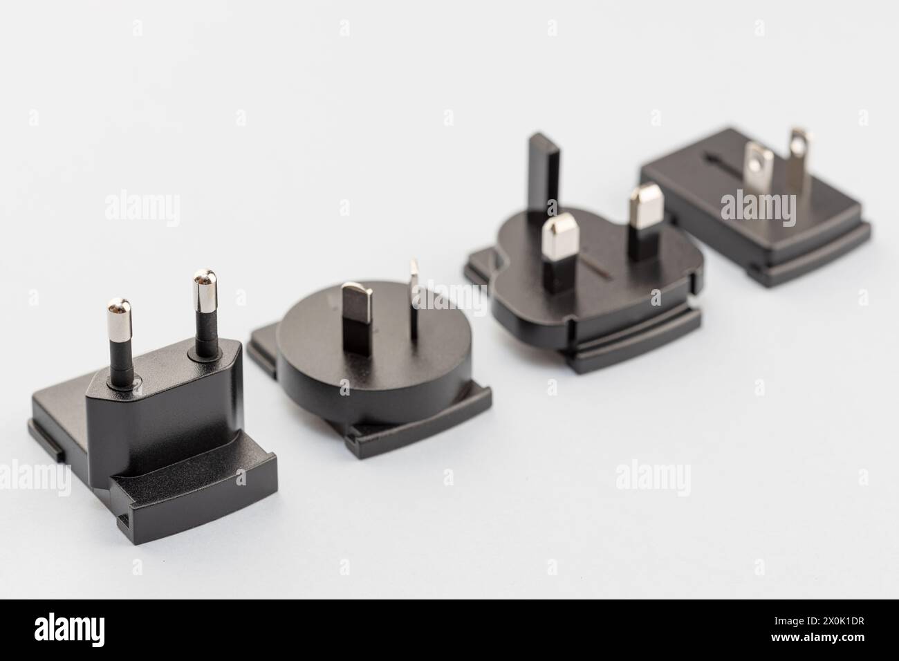 Variety of electrical plugs from different regions worldwide isolated on gray background Stock Photo