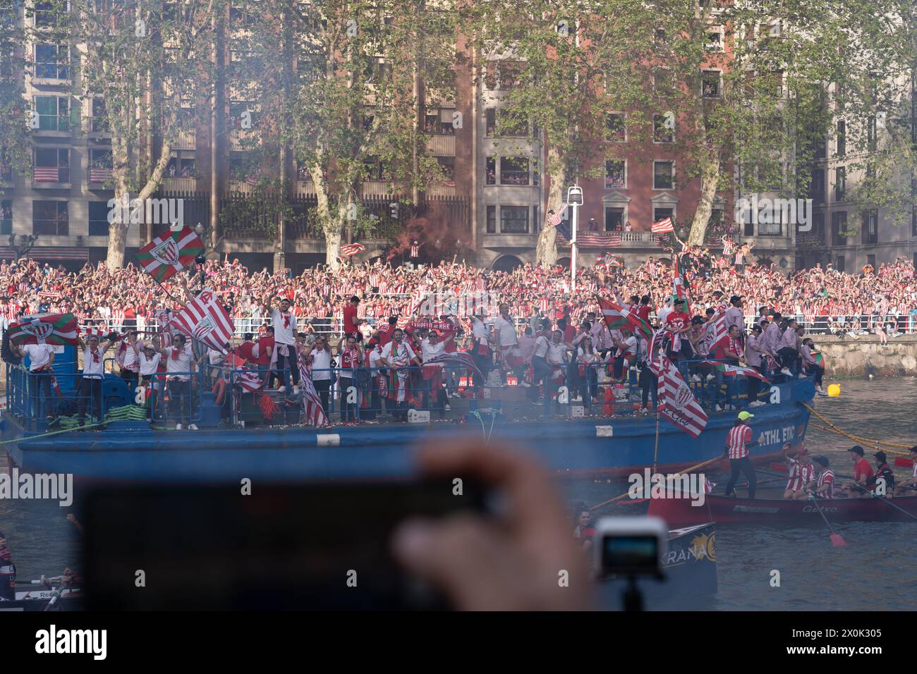 Bilbao, Biscay, Spain - April 11th 2024 - Athletic Club de Bilbao fans celebrate the 25th Copa del Rey title with the barge Stock Photo