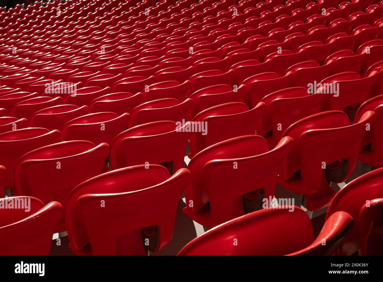 Symmetry pattern of red seats in a football stadium Stock Photo