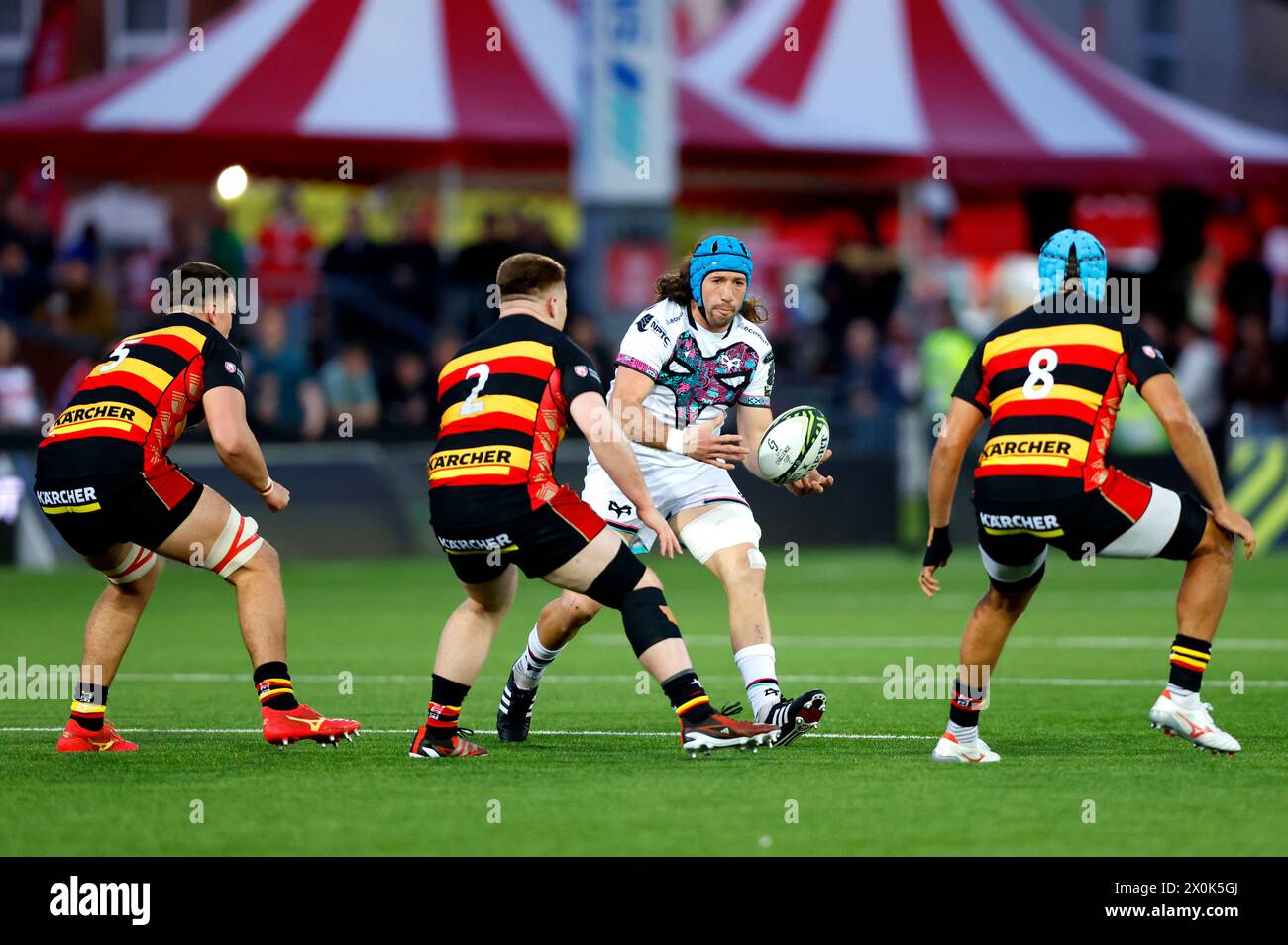Ospreys' Justin Tipuric (centre) evades being tackled by Gloucester's Sebastian Blake during the EPCR Challenge Cup quarter-final match at Kingsholm Stadium, Gloucester. Picture date: Friday April 12, 2024. Stock Photo