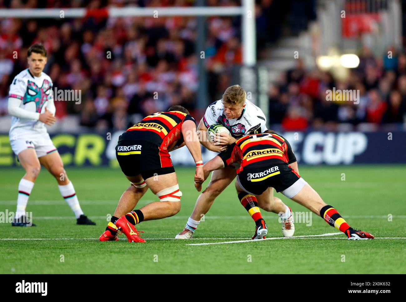 Ospreys' Kieran Williams (centre) is tackled by Gloucester's Seb Atkinson and Freddie Thomas during the EPCR Challenge Cup quarter-final match at Kingsholm Stadium, Gloucester. Picture date: Friday April 12, 2024. Stock Photo