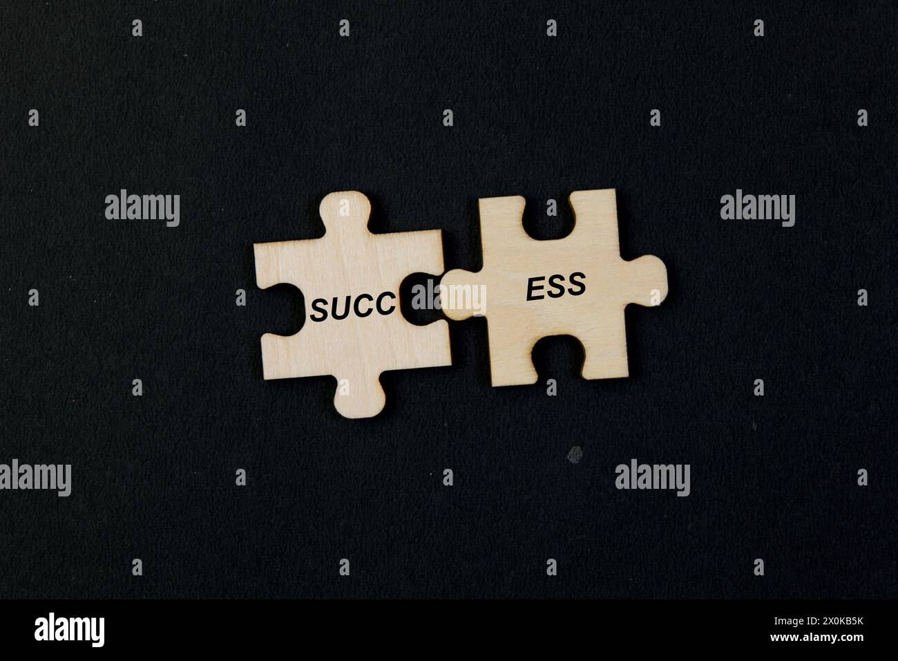 Image of jigsaw puzzle pieces coming together to form the word 'SUCCESS,' symbolizing the concept Stock Photo