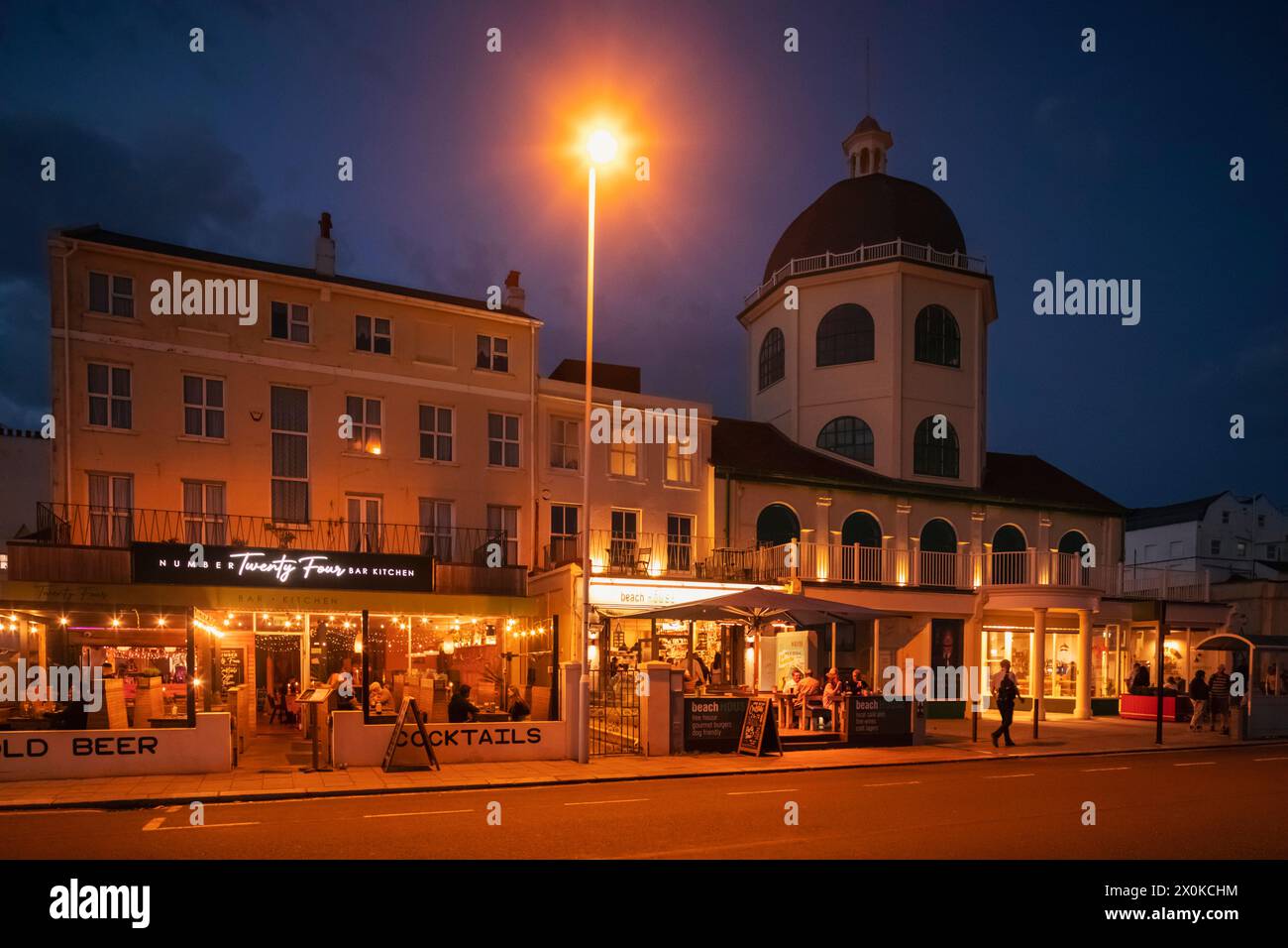England, West Sussex, Worthing, Marine Parade, The Dome Cinema and Bars at Night Stock Photo