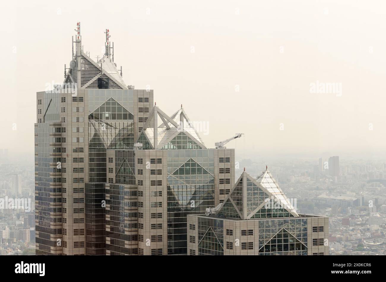 A tall building with a lot of windows and a triangular roof. The ...