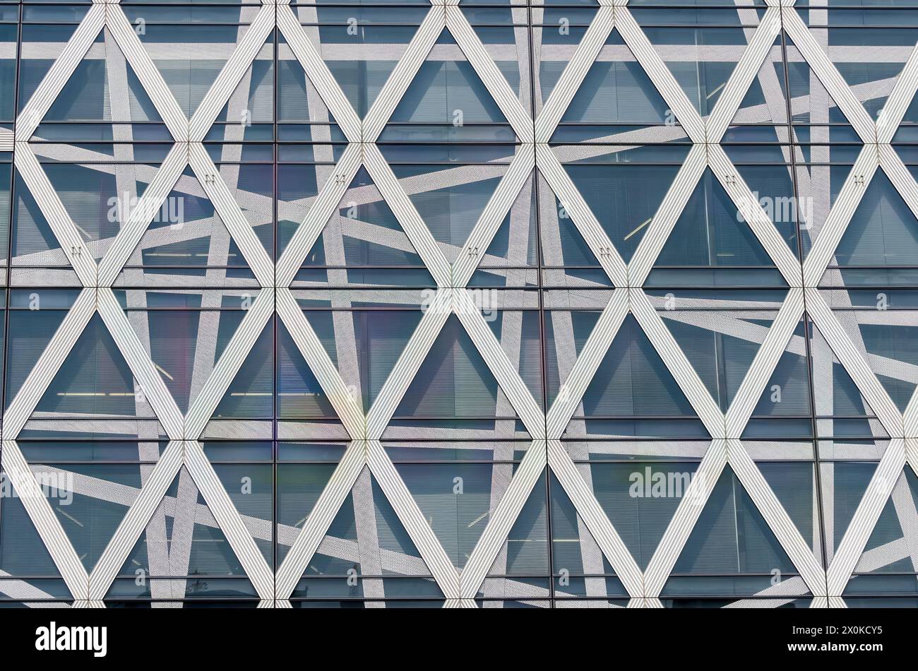 A building with a lot of white and black triangles. The triangles are arranged in a way that creates a sense of movement and energy. The building appe Stock Photo