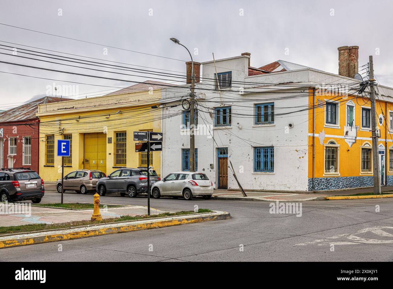 Colorful houses at a crossroads. Punta Arenas, Patagonia y la Antarctica Chilena, Chile. Stock Photo