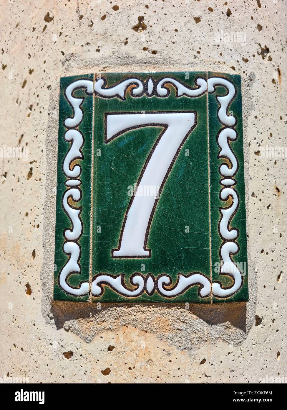 A ceramic tile with the house number 7 on a wall, Majorca, Spain Stock Photo