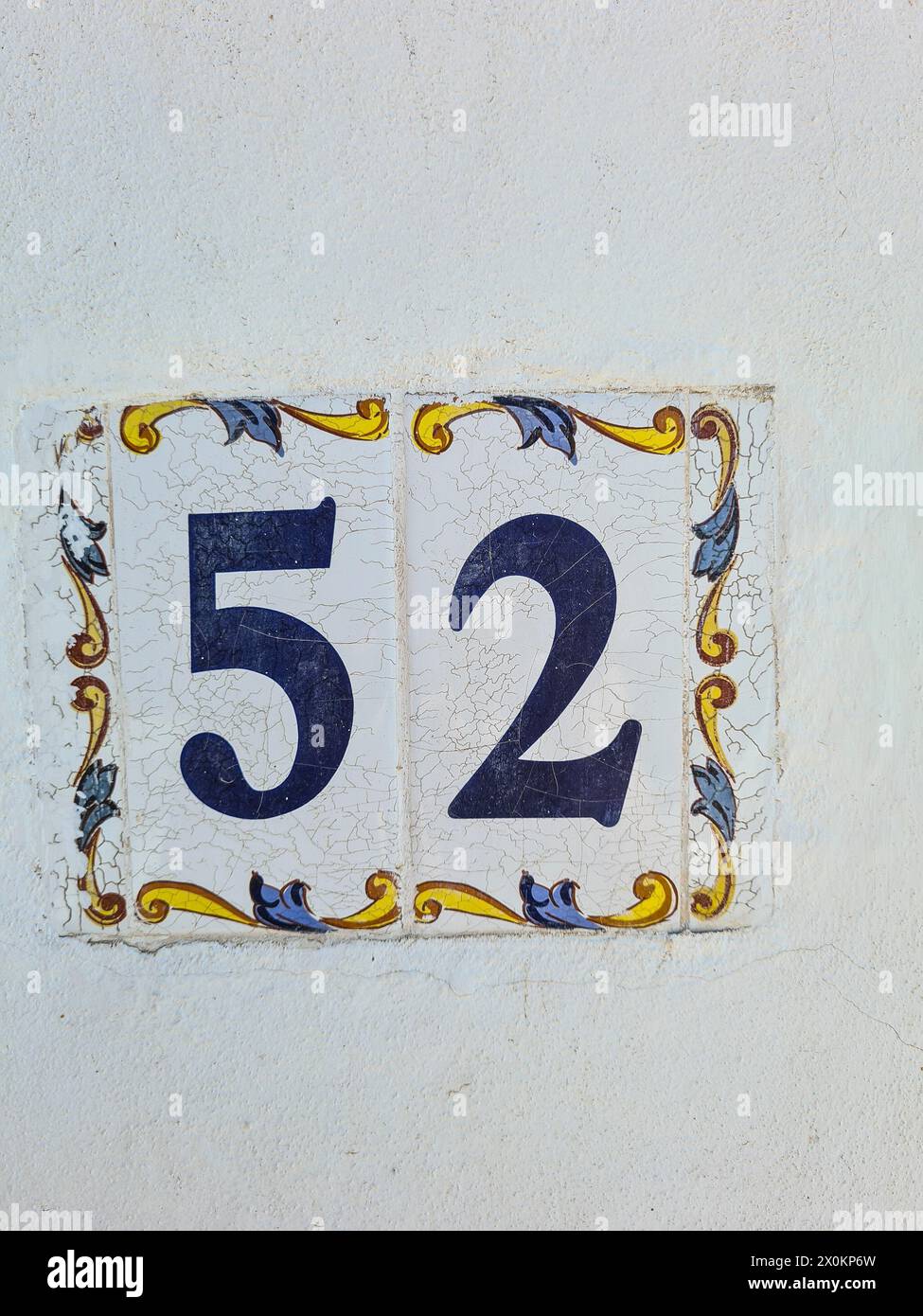 A ceramic tile with the house number 52 on a white wall, Majorca, Spain Stock Photo