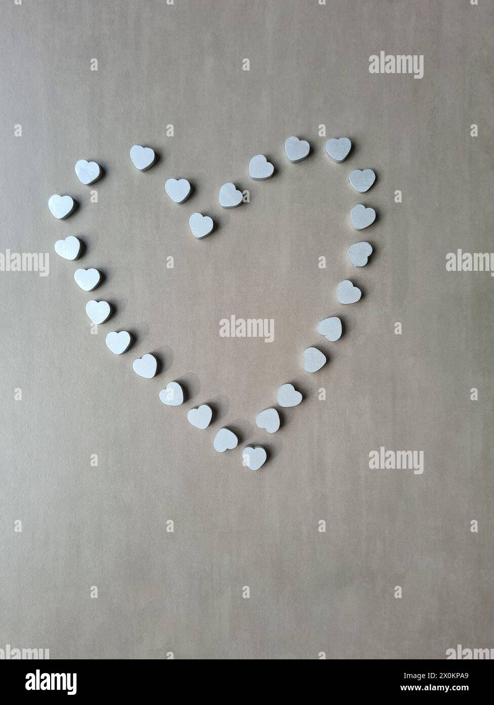 A large silver-colored heart made of lots of small silver hearts as a sign of love for Mother's Day Stock Photo
