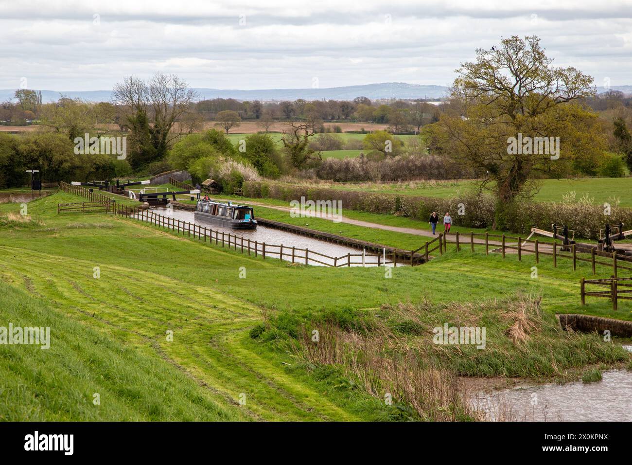 Canal narrowboat passing through the Hurleston flight of lock on the Llangollen canal after leaving the Shropshire Union canal at Hurleston junction Stock Photo
