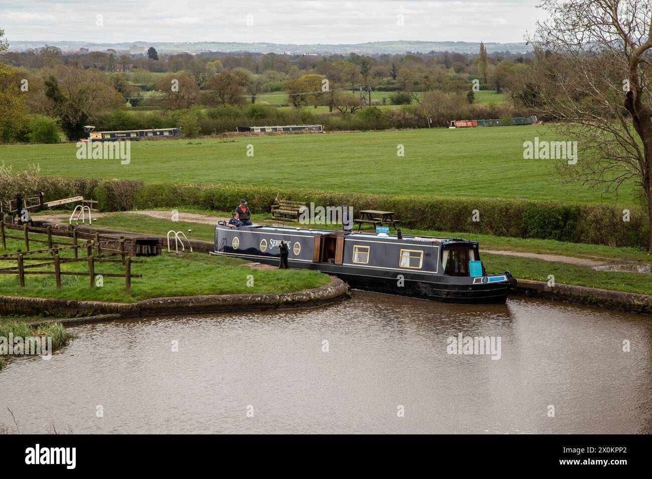 Canal narrowboat passing through the Hurleston flight of lock on the Llangollen canal after leaving the Shropshire Union canal at Hurleston junction Stock Photo