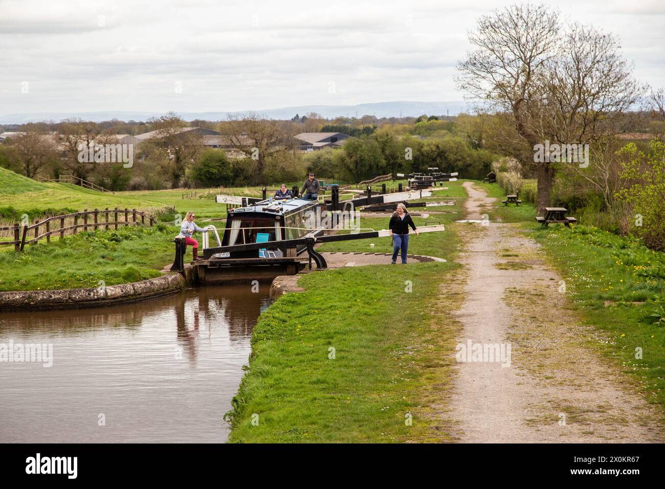 Canal narrowboat passing through the Hurleston flight of lock on the Llangollen canal after leaving the Shropshire Union canal at Hurleston junction Stock Photo