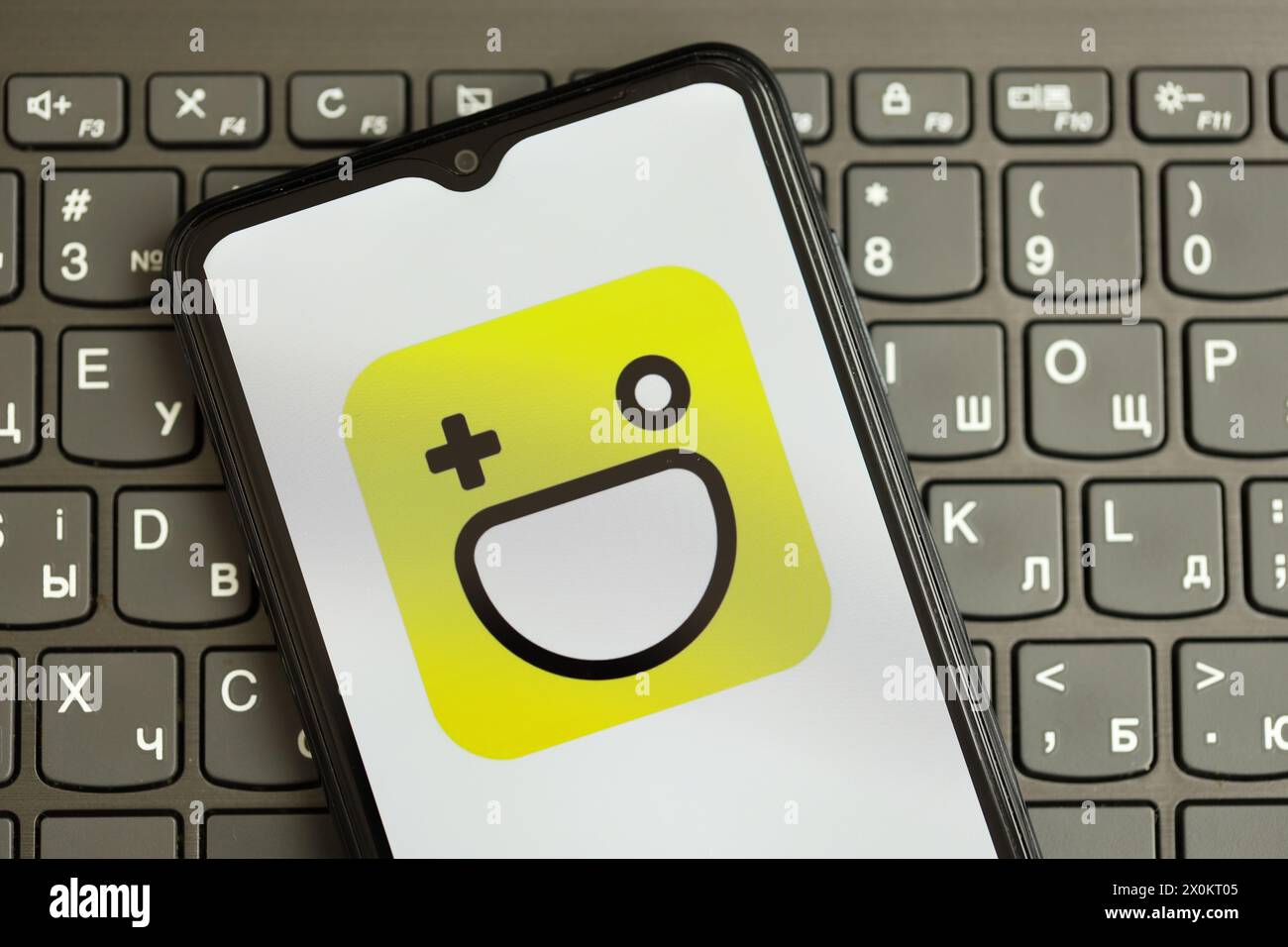 KYIV, UKRAINE - APRIL 1, 2024 Hago icon on smartphone screen on black keyboard close up. iPhone display with app logo on dark keypad buttons Stock Photo