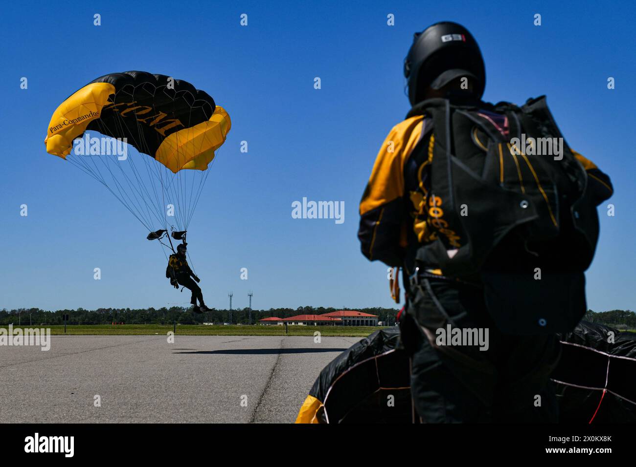 U.S. Army Staff Sgt. Mike Williams, a member of the U.S. Special Operations Command Para-Commandos, prepares to land during the opening of the Tampa Bay AirFest at MacDill Air Force Base, Florida, March 29, 2024. The Para-Commandos are the U.S. SOCOM's premier parachute demonstration team who perform at events across the nation, informing the public about U.S. SOCOM, its mission, and the contributions more than 70,000 Soldiers, Sailors, Airmen, Marines, Guardians and Department of Defense Civilians are making across the U.S. and in more than 70 countries around the globe. Tampa Bay AirFest was Stock Photo