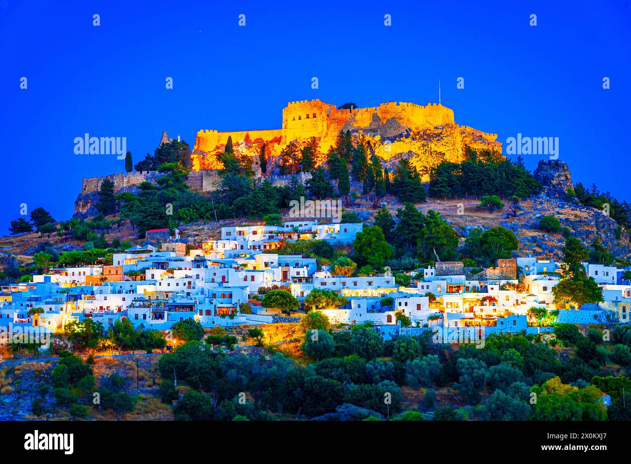 Lindos city on Rhodes island, Greece. Small whitewashed village and the Acropolis, on Rhodos Island, Greece at Aegean Sea Stock Photo
