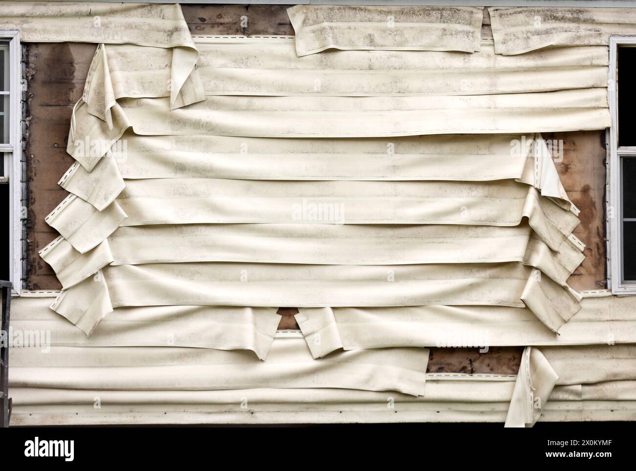 An exterior of a home that has damaged and melted plastic vinyl siding