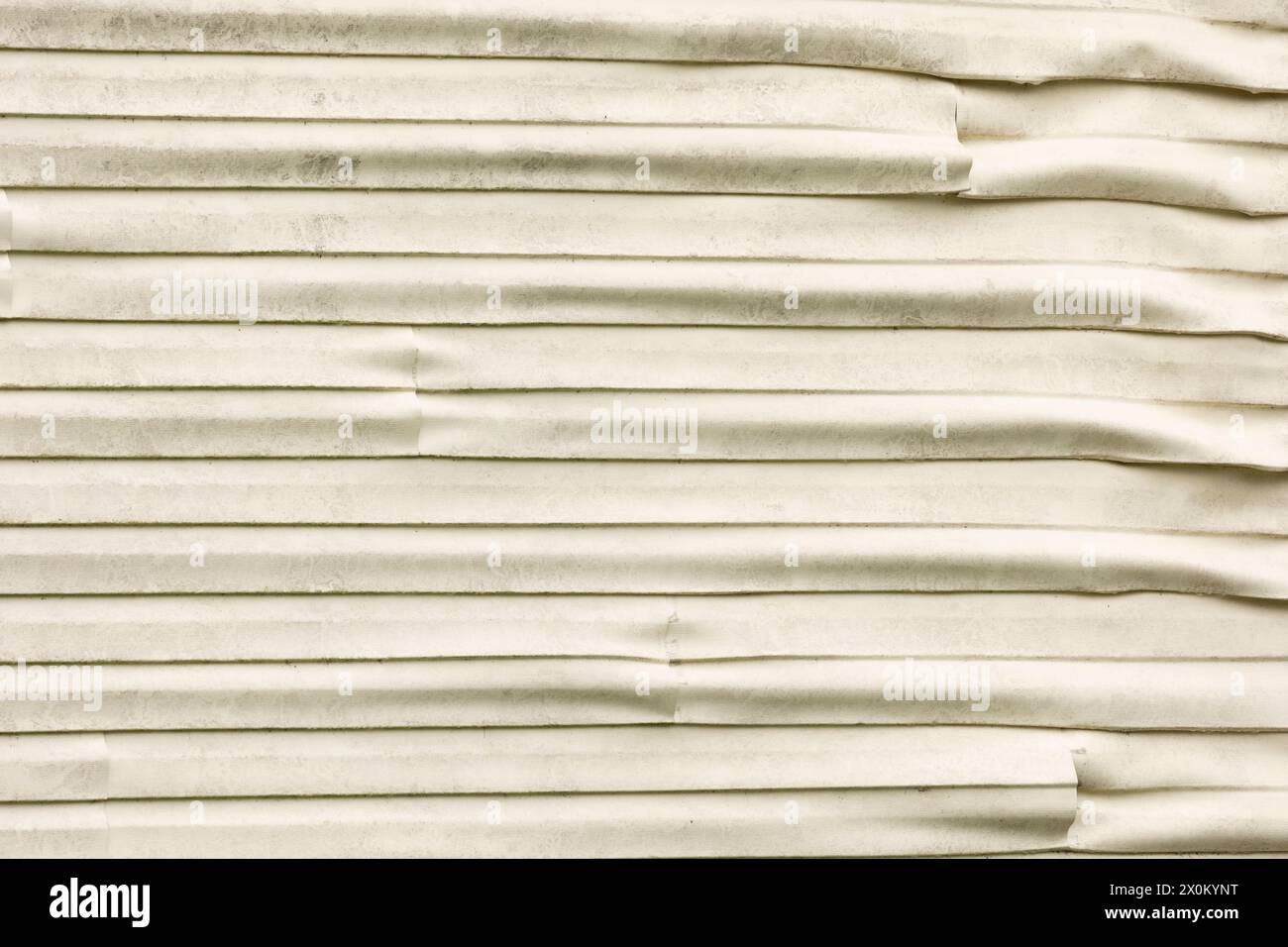 The dirty plastic vinyl siding on a home that was damaged and melted slightly from a hot structure fire nearby. Stock Photo
