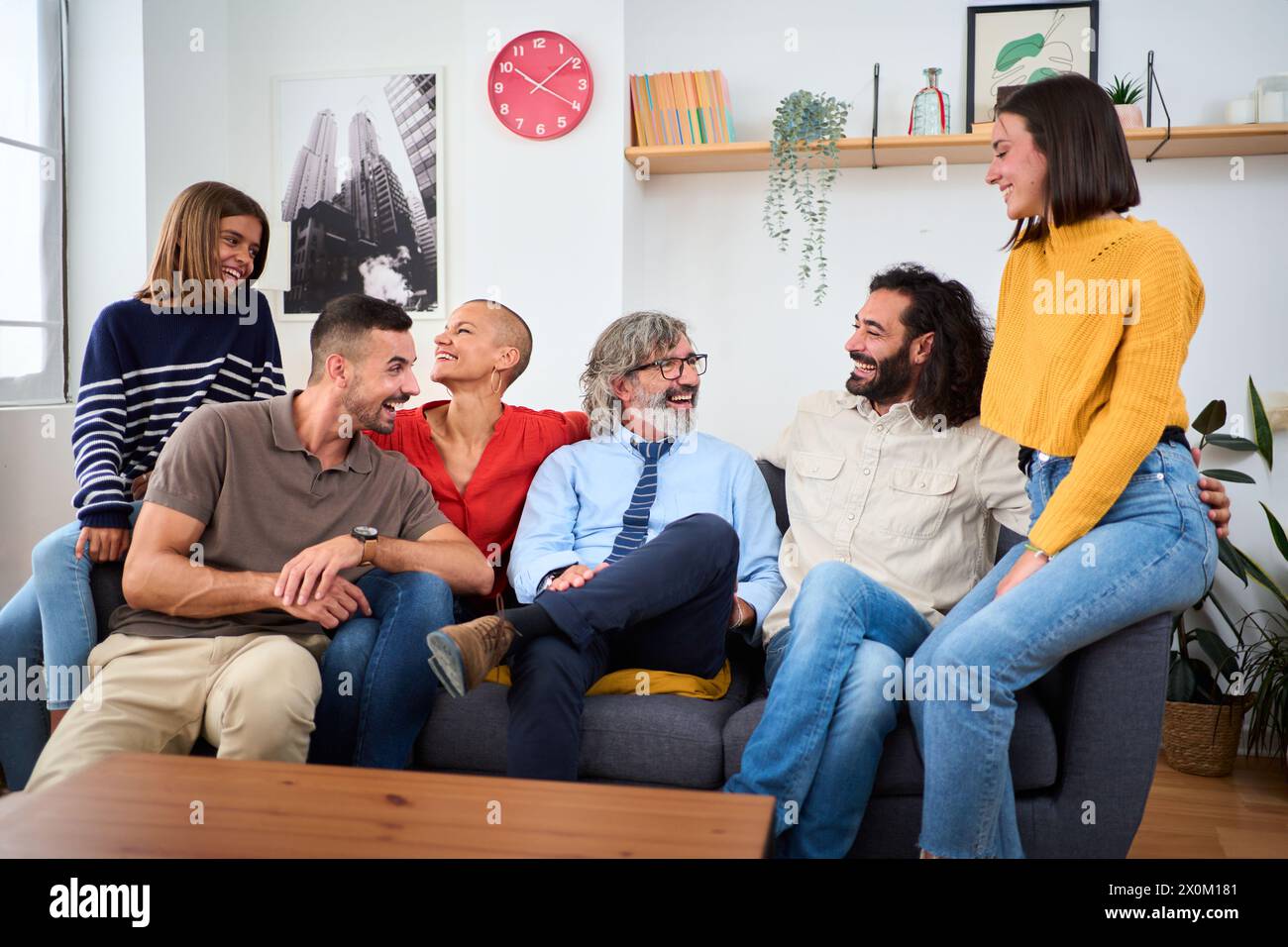 Family sitting together on sofa hi-res stock photography and images - Alamy