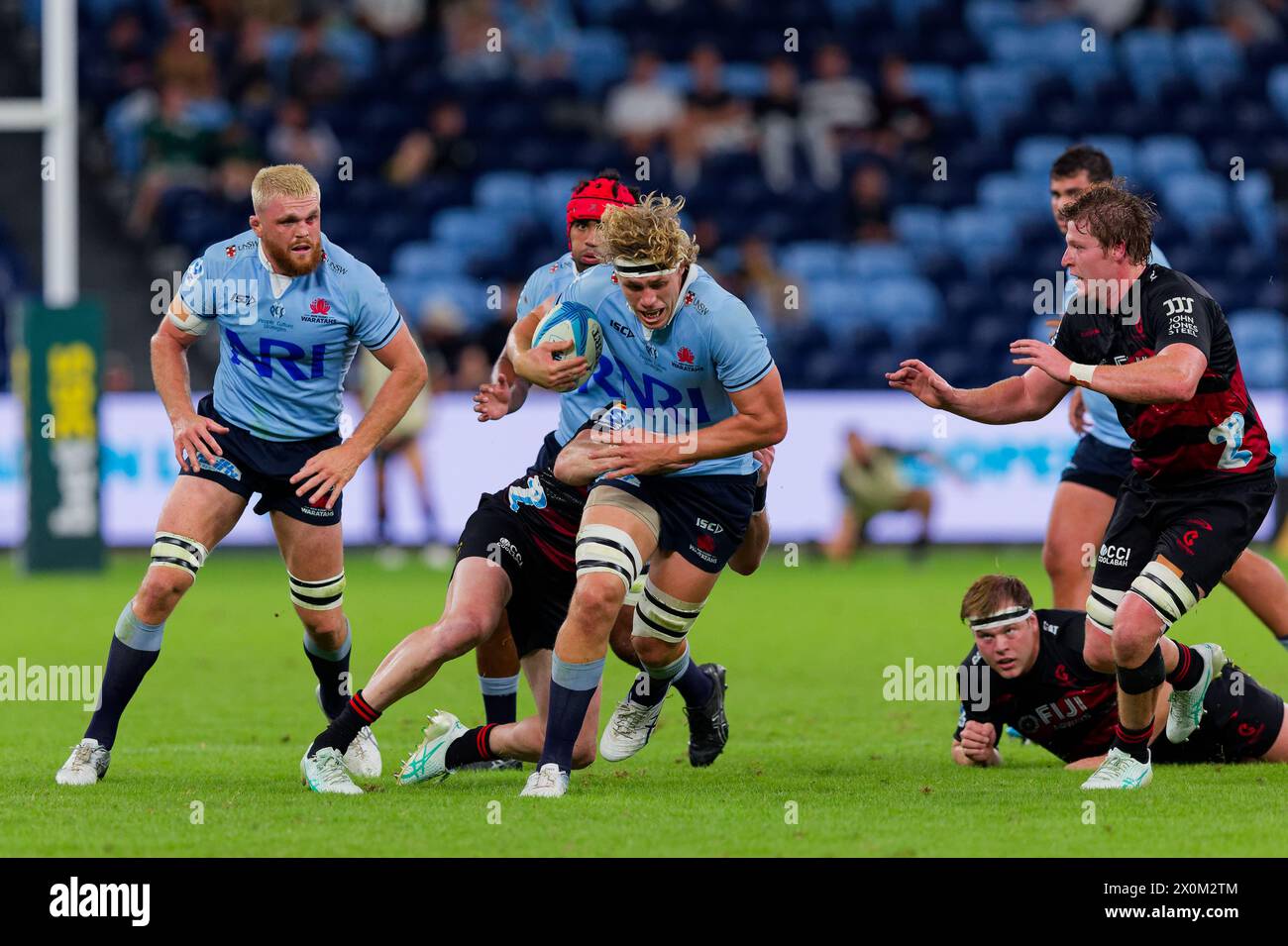 Sydney, Australia. 12th Apr, 2024. Ned Hanigan of the Waratahs is tackled during the Super Rugby Pacific 2024 Rd8 match between the Waratahs and the Crusaders at Allianz Stadium on April 12, 2024 in Sydney, Australia Credit: IOIO IMAGES/Alamy Live News Stock Photo