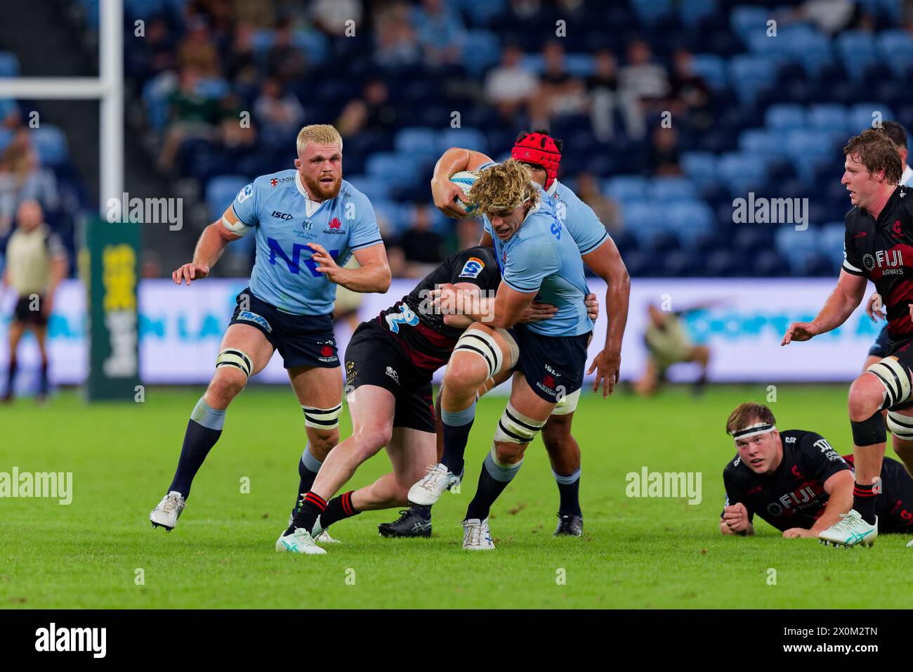 Sydney, Australia. 12th Apr, 2024. Ned Hanigan of the Waratahs is tackled during the Super Rugby Pacific 2024 Rd8 match between the Waratahs and the Crusaders at Allianz Stadium on April 12, 2024 in Sydney, Australia Credit: IOIO IMAGES/Alamy Live News Stock Photo