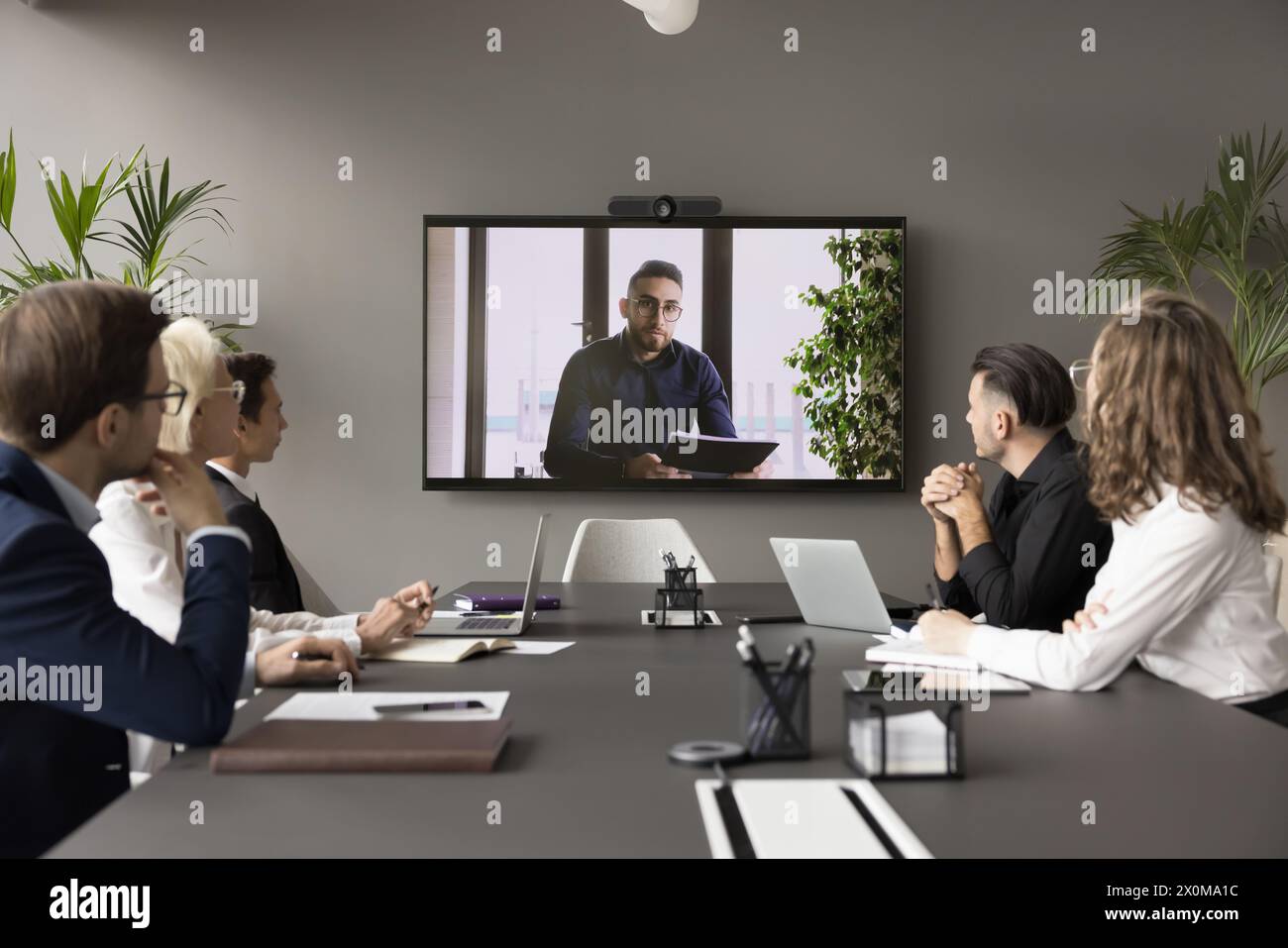 Arabic businessman speaker lead videoconference for staff using modern application Stock Photo
