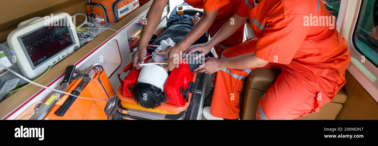 A person is wearing an oxygen mask, getting help from paramedic in ...