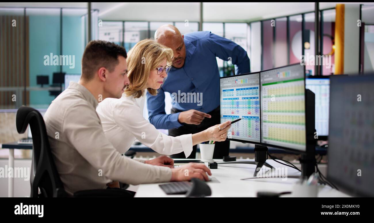 Analyst Employee Working On Spreadsheet Using Desktop Computer Stock Photo