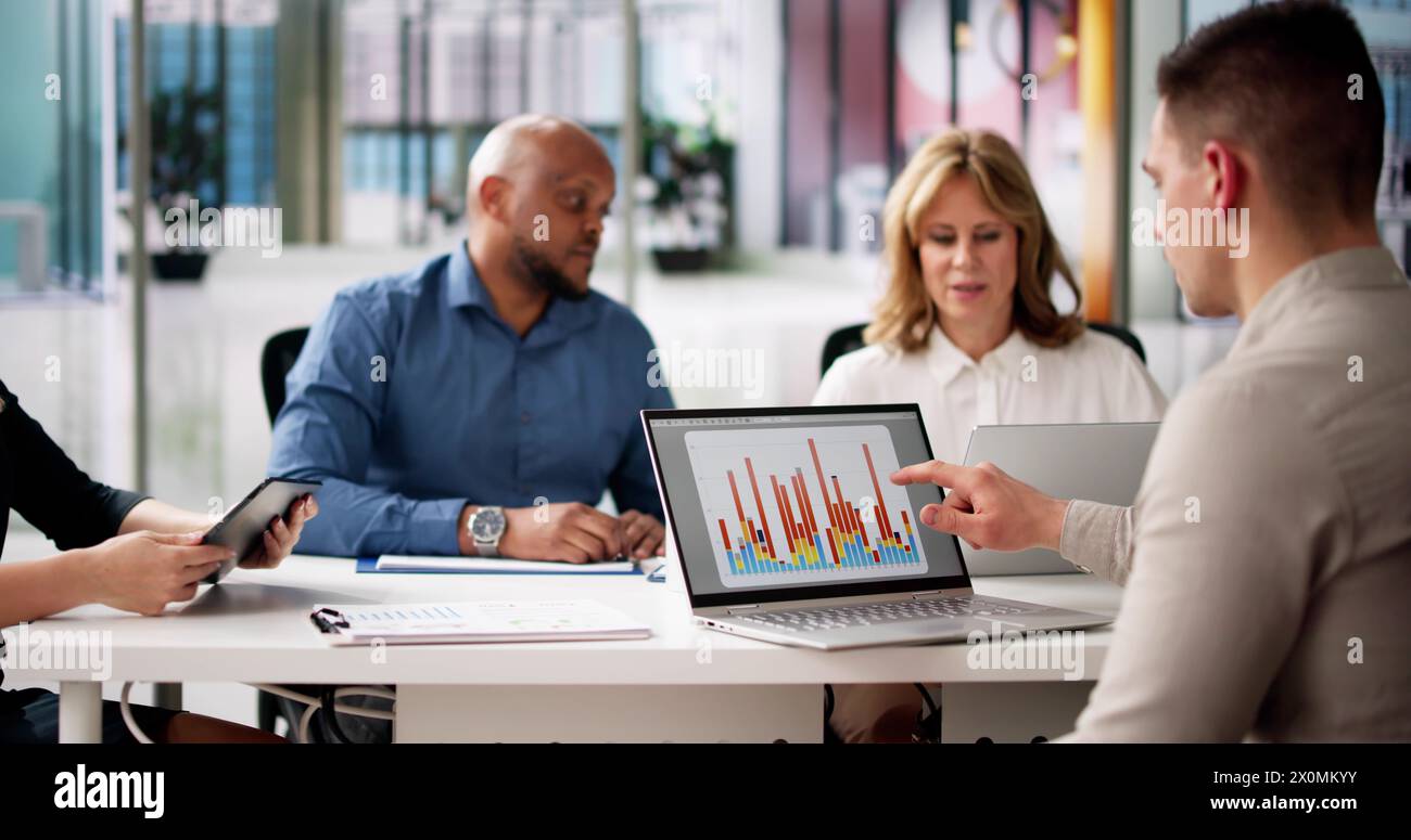 Predictive Business Analytics On Laptop Computer. Group Of Analysts Stock Photo