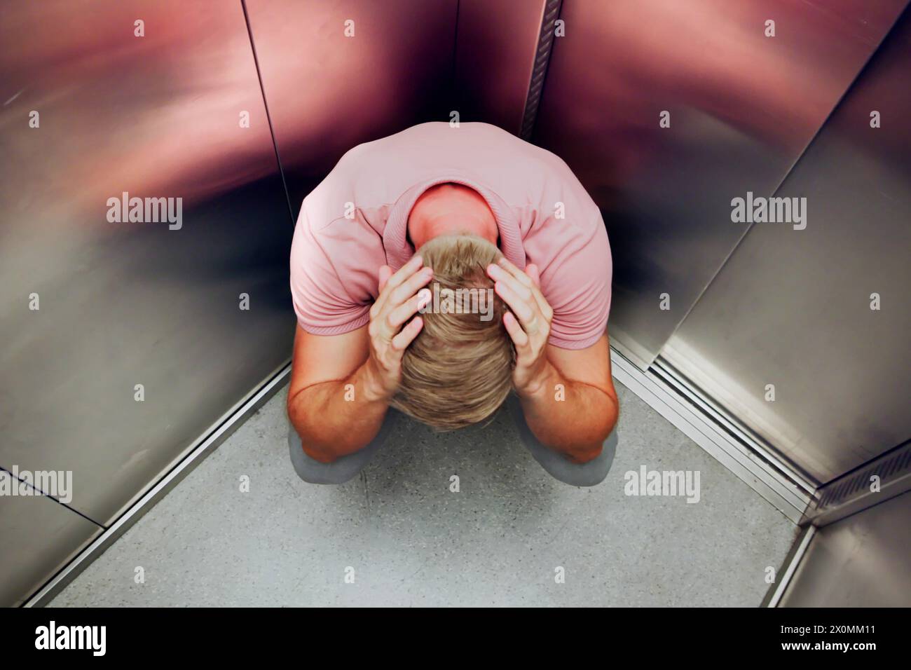 Man Trapped Inside Elevator: Overcoming Claustrophobia and Fear Stock Photo