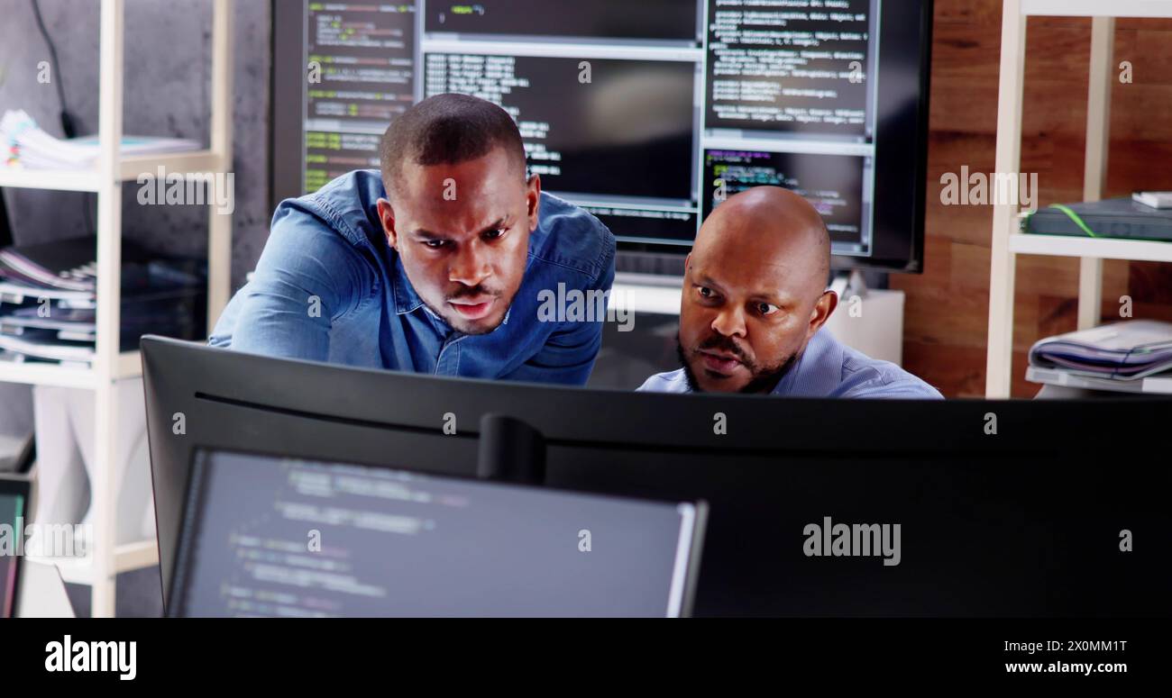Working Business Team of African Code Developers on Computers Stock Photo