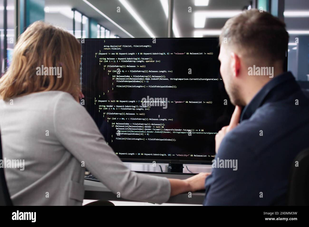 Agile software developer using computer at desk Stock Photo