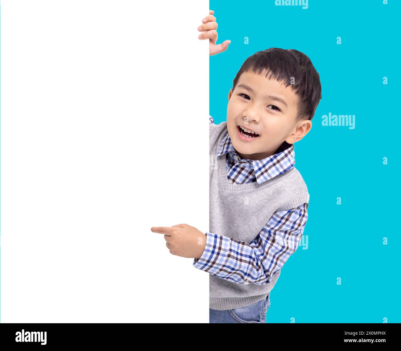 Happy Asian boy  holding and pointing white  empty banner Stock Photo