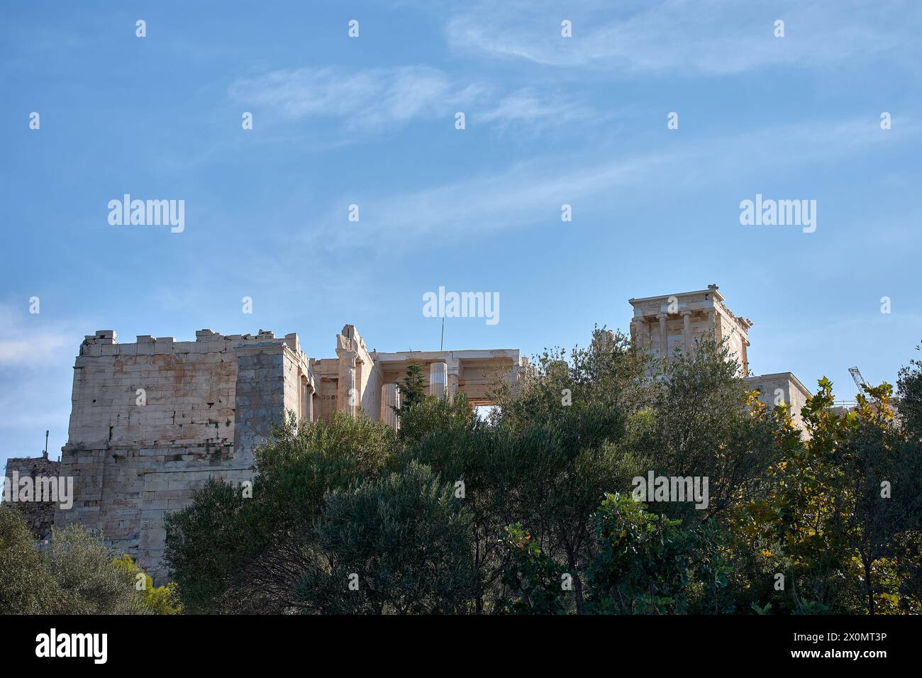 General view of the Parthenon and the ancient Acropolis of Athens Greece from a low area between trees Stock Photo