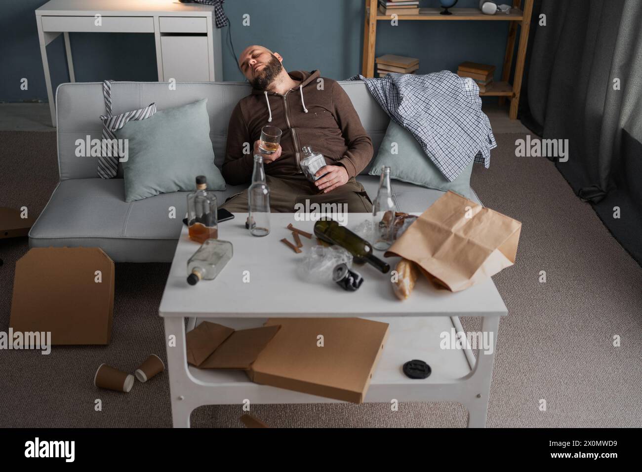 After drinking. Drunk bearded man sitting on sofa and sleeping after