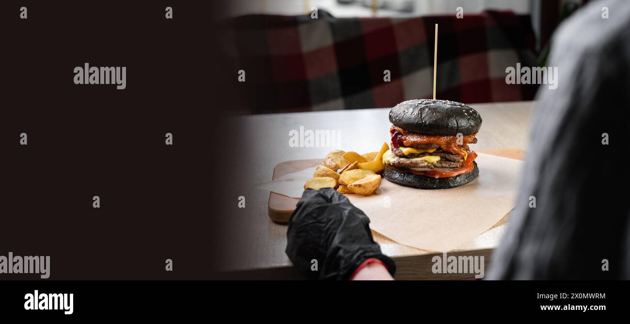 View Over The Shoulder Of A Woman In Black Gloves About To Eat A 