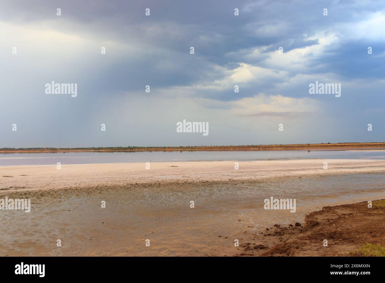 Dark storm clouds over a salt lake before a rain Stock Photo
