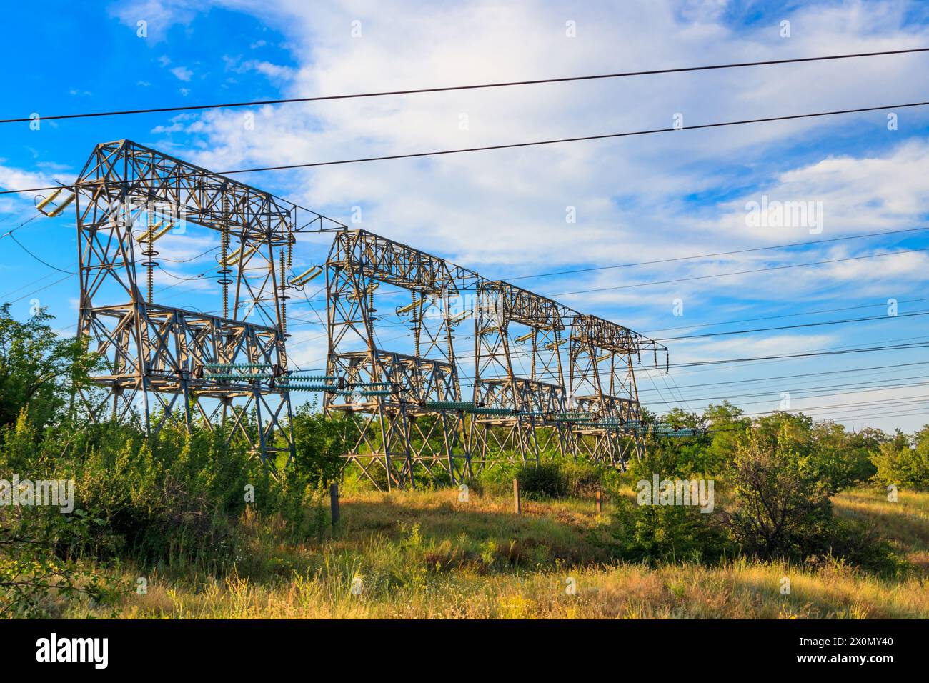High voltage power line against blue sky Stock Photo - Alamy