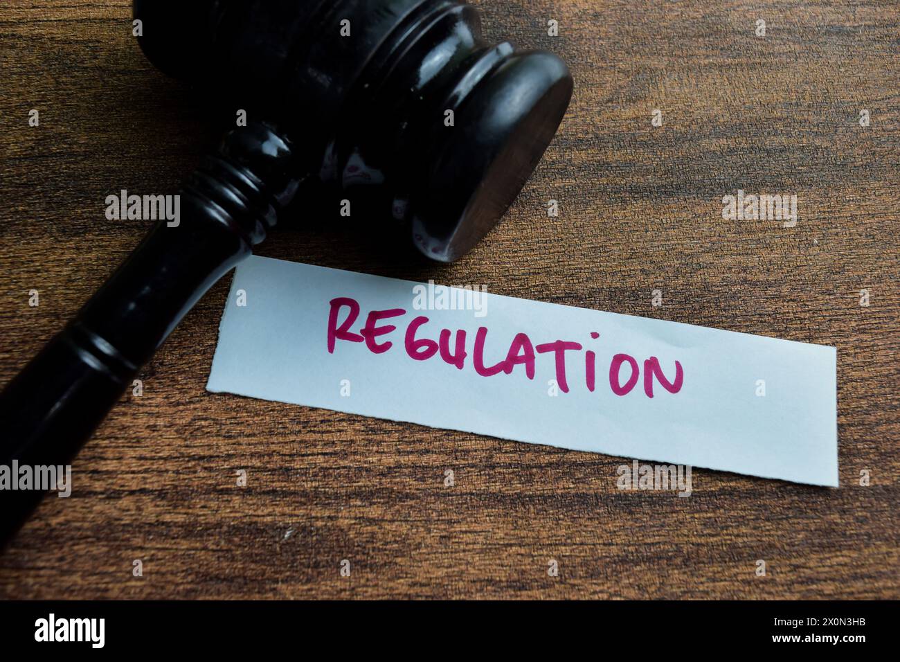 Concept of Regulation write on sticky notes isolated on Wooden Table. Stock Photo