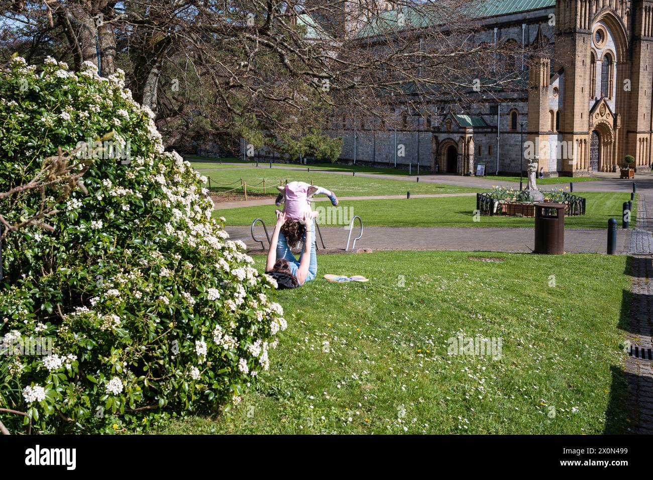 Mother and daughter playing in the grounds of Buckfast Abbey, Buckfast, Devon, England. Stock Photo