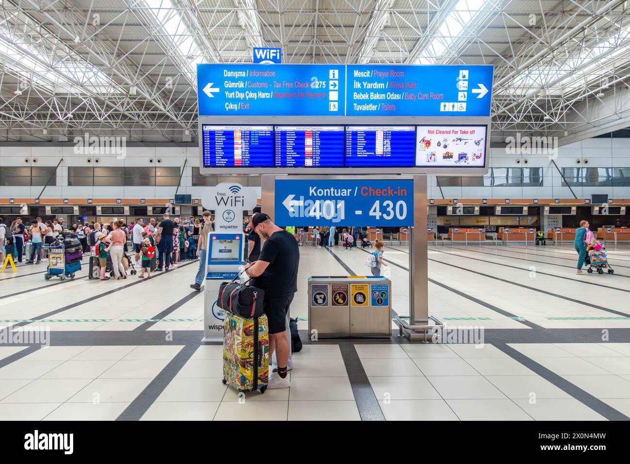 Departure boards in the check-in hall at Antalaya Airport Terminal 2 in Antalaya Turkey Stock Photo