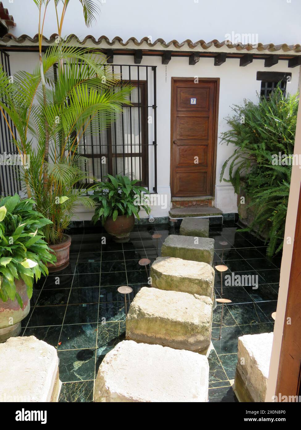 Casa Encantada .Boutique small, intimate hotel in Antigua.Calle Poniente. Guatemala, Central America. Stylish stepping stones to some of the bedrooms. Stock Photo