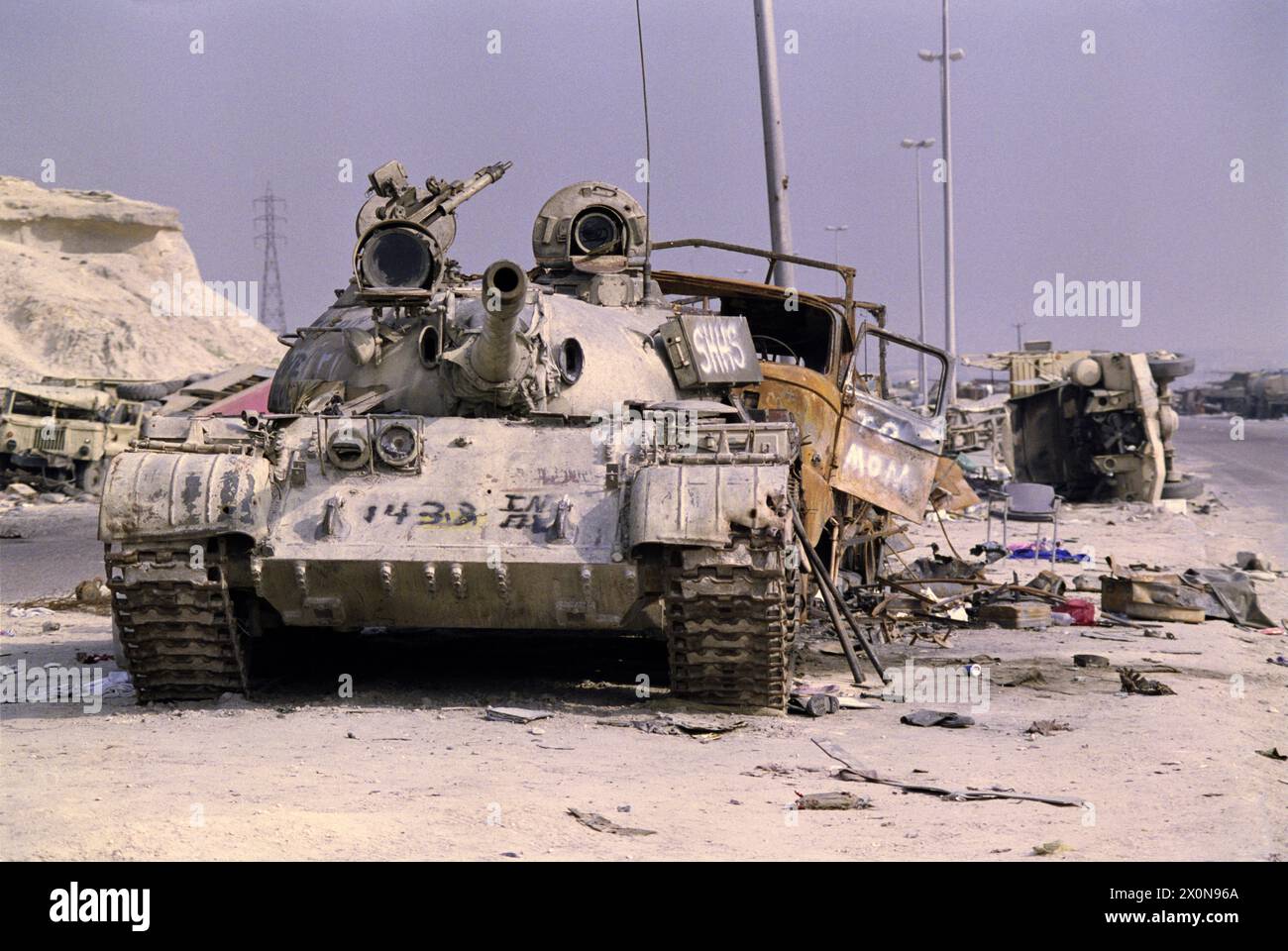 1st April 1991 An abandoned Iraqi T55 tank among the devastation on the “Highway of Death”, the main highway to Basra, west of Kuwait City. Stock Photo