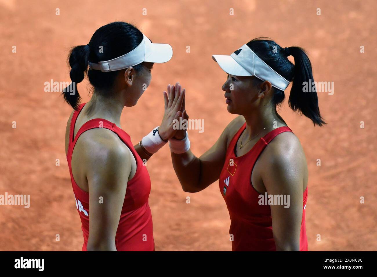 Changsha, China's Hunan Province. 13th Apr, 2024. Wang Xinyu (L)/Guo Hanyu of China react during the women's doubles match against Kim Dabin/Park Sohyun of South Korea at the Billie Jean King Cup 2024 tennis tournament Asia-Oceania Group I match in Changsha, central China's Hunan Province, April 13, 2024. Credit: Chen Zhenhai/Xinhua/Alamy Live News Stock Photo